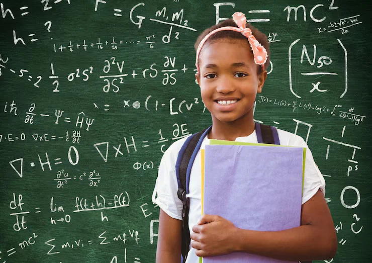 Schoolgirl in Front of Classroom Chalkboard