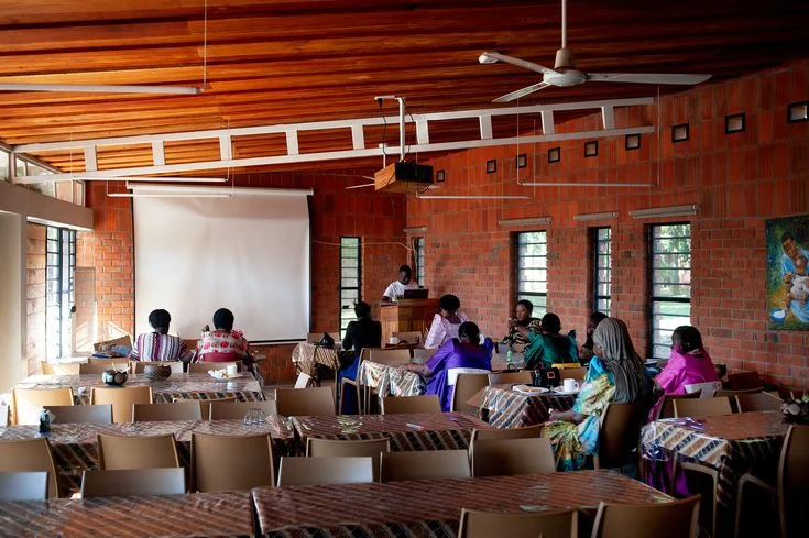 A fieldworker speaking with members of a rural community during a data collection exercise