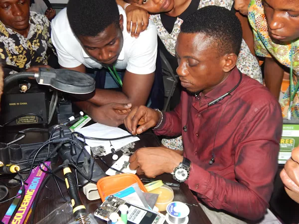 Youth learning phone engineering skills in empowerment training