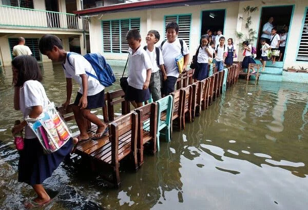 Flooded classroom showing how climate shocks displace childhood education