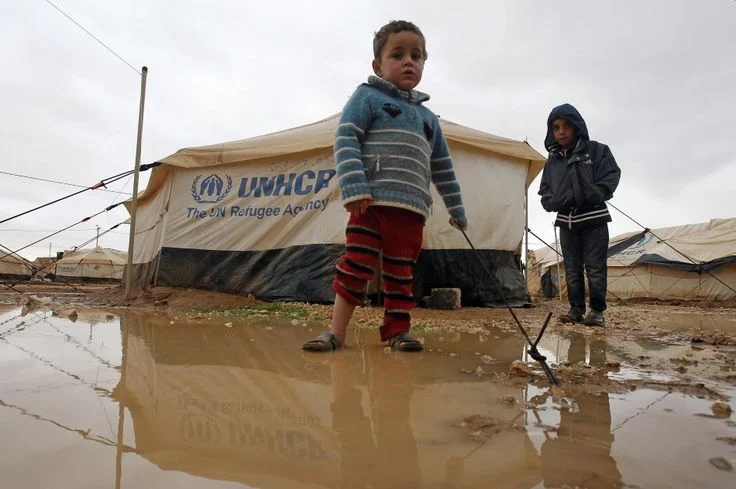 Child in displacement camp facing protection risks during climate shocks