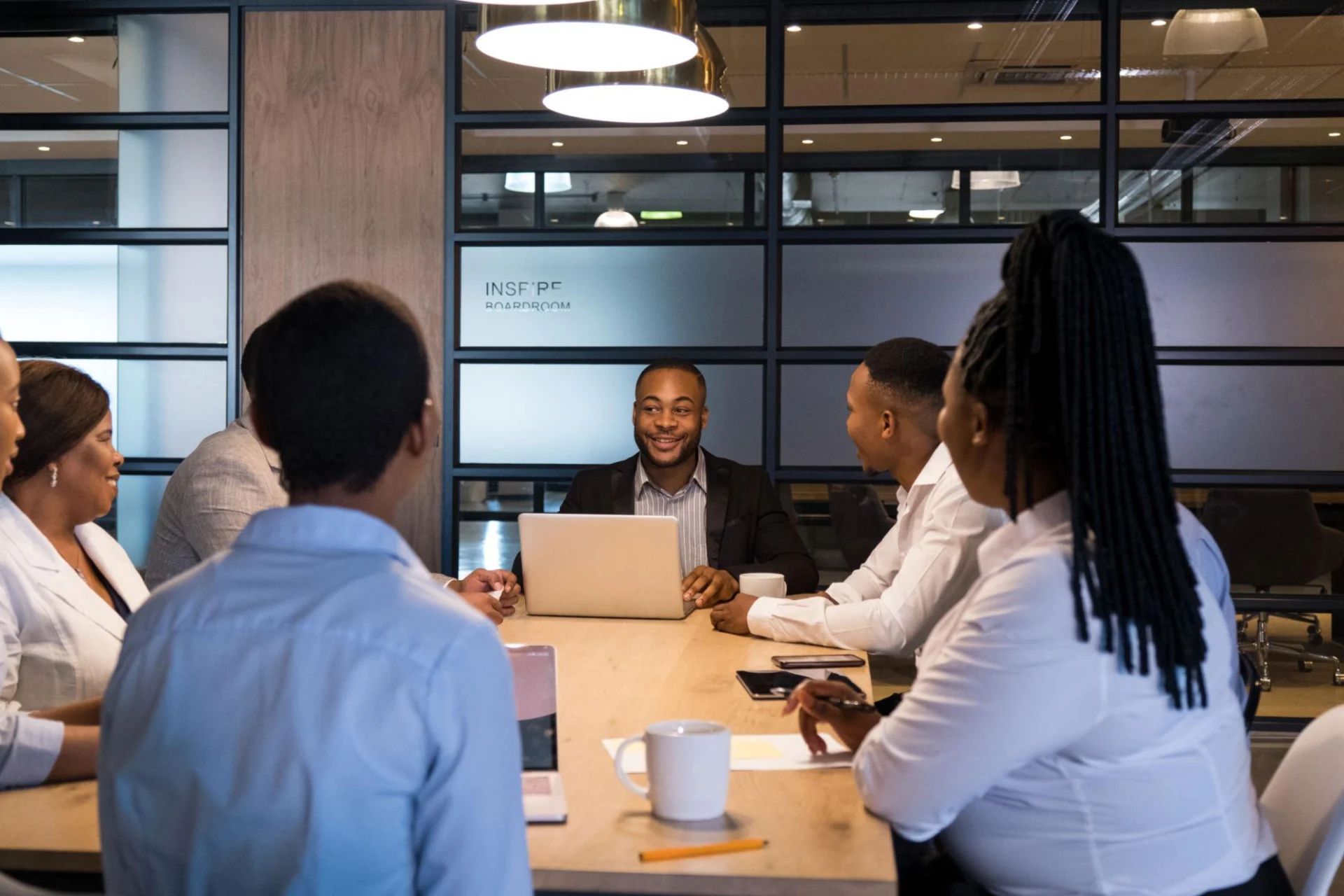 Young African professionals discussing career and business opportunities, illustrating how fairness and access can influence economic participation.