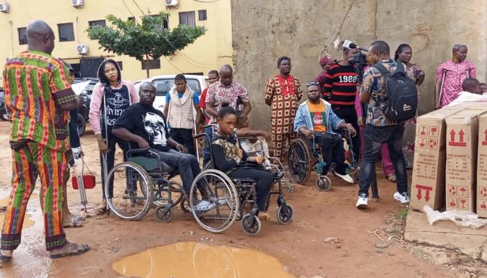 Community residents travelling through a rural Nigerian settlement where access to services may require additional support.